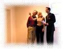 A couple looking at their home with a realtor.
